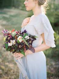 A lush and bold wedding bouquet with king proteas, burgundy and plum blooms and bold leaves for a fall boho. Wedding Bouquets Inspiration Rich Blackberry Farm Fall Inspiration Www Stylemepretty Photography Mega Weddingtrend Home Of Bridal Trends The Hottest New Wedding Trends Straight From The Experts