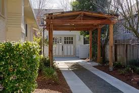 The project features instructions for building a double carport made from wood, having a flat roof and sharp modern design. Covered Driveway Garage Traditional With Pergola Garage Door Pergola Pergola Modern Pergola Pergola Designs