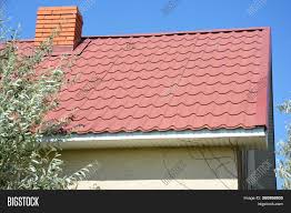 For example, if you have a very bold, colored home, such as a barn red, then any roof color is going to contrast it. House Red Metal Roof Image Photo Free Trial Bigstock