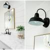 Matte black and brass vanity light. 1