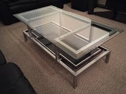 Features a transitional design inspired by ancient horse bridles. Metal Glass Coffee Table Paul Spinak