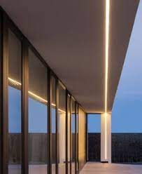 Many of our recessed ceiling luminaires include glass just below the surface to spark visual interest. Linear Recessed Fixture Exterior With Corner Detail Facade Lighting Facade House Canopy Lights