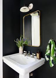 Aim to keep the space feeling clean and fresh with the wallpaper pattern you choose. Powder Room With Black Walls And White Pedestal Sink Transitional Bathroom