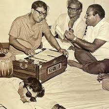 Daak - The famed musical duo, Mohammed Rafi and R D Burman, in a practice session, 1970s. Not completely sure but it does look like Devanand stretched out on the left hand