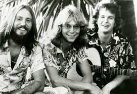 The band America - Dan Peek, Dewey Bunnell, and Gerry Beckley. Only Bunnell  and Beckley remain nowadays. Gerry always kinda looked like John Denver's  kid brother.