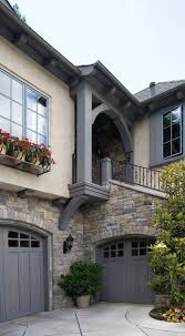 The original part is timber framed and roughcast, the extensions are in brick, all is a timber framed house with rendered infill, partly rendered and partly refaced in limestone, and with a slate roof. Limestone Eldorado Stone