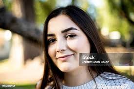 Flirtatious Look Of A Young Woman In A Park Stock Photo