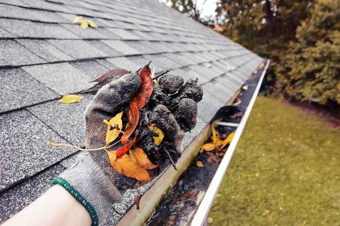 Downspout running down the side of a house to carry rainwater away from the foundation