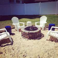 Create the first tier of the fire pit by forming a circle, alternating the large and mini bricks to create a pattern. Fire Pit Sand Ring And Adirondack Chairs Beach Theme Backyard Backyard Vacation Backyard Beach