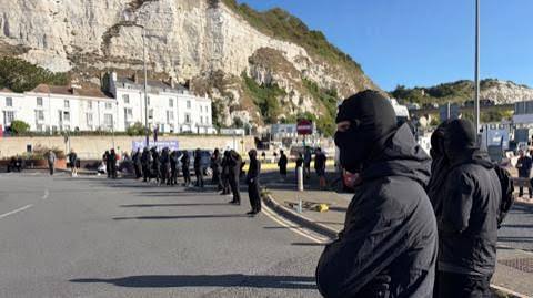 Port of Dover delays: Disruption as masked 'stop the boats' protesters block roads - BBC News