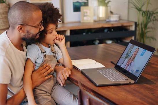 father and son on telehealth therapy appointment