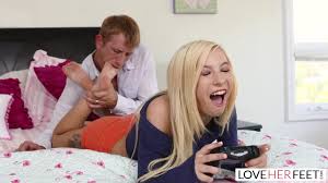 Tiny blonde Kenzie Reeves gives a footjob and fucks while playing video  games - Feet9