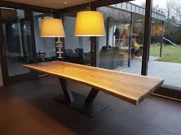 Learn everything an expat should know about managing finances in germany, including bank accounts, paying taxes, getting insurance and investing. Contemporary Dining Table Kauri Unik Solid Wood Epoxy Lacquered Metal Base