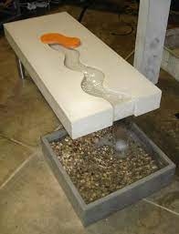 A coffee table is a low table designed to be placed in a sitting area for convenient support of beverages, remote controls, magazines, books (especially large, illustrated coffee table books), decorative objects, and other small items. Modern Concrete Coffee Table With Water Fall Concrete Coffee Table Granite Table Concrete Furniture