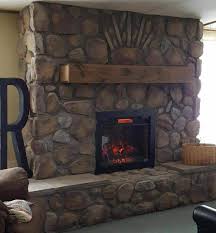 The faux stone paneling on this fireplace surround transforms an otherwise plain drywall surround for a gas fireplace into something much more impressive and costly this is a gorgeous example of a dark stone facade on a fireplace surrounded fitted with a large television and cabinetry on either side. The Four Factors That Will Determine Stone Veneer Project Cost Mason S Mark Stone Veneer