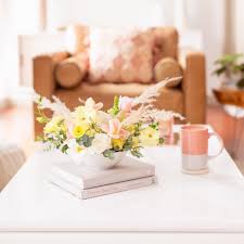 The antique silver trays pull the styles together with color, and the warm burlap, wood, glass and ceramic items, plus that unique bouquet, really create a focal point. A Pastel Easter Flower Arrangement Justinecelina