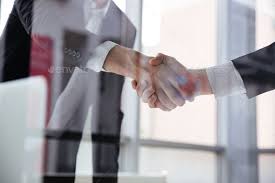 Two Businessmen Standing And Shaking Hands In Office Business Man Brand Experience Financial Services