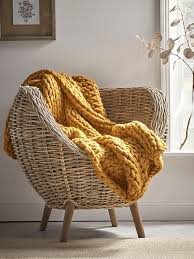 This gorgeous arm knit basket masterpiece by anne weil is made from merino wool knitting yarn, and the baskets are folded double thick, making it easy and sturdy enough to stand on its own. Chunky Knit Throw Mustard