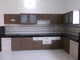 Pops of orange infuses energy into a small kitchen design scheme. Quality Modular Kitchen Kokan Connect