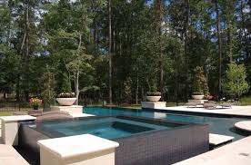 This Spa And Swimming Pool With Its High Contrast Black Tile And Travertine Coping Are Engaged With Additional Dram Swimming Pool Tiles Pool Patio Pool Hot Tub