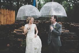 What To Do If It Rains On Your Wedding Day Wedding Couple Under Clear Umbrellas Cpbride Com Blog Clear Umbrella Wedding Umbrella Wedding Perfect Bride