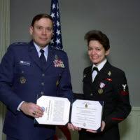 U.S. Air Force MAJ. GEN. John P. Jumper (left), SENIOR Assistant to the  Secretary of Defense, poses with U.S. Air Force SENIOR AIRMAN Lisa M. Poole  (right) for an official photograph after