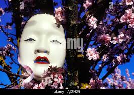 Blossom cherry branches in craft clay vase