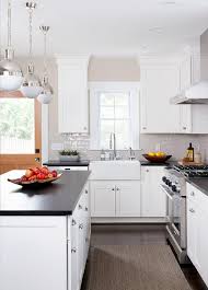 White shaker cabinets with black hardware creating an elegant room is actually not too difficult, with the combination of white cabinets with black hardware you can make the room feel more luxurious. Light Gray Glazed Kitchen Tiles With White Shaker Cabinets Transitional Kitchen