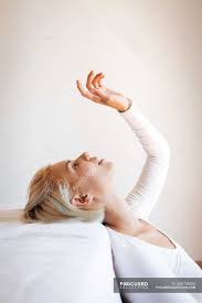 Find the perfect beautiful blond woman stock photo. Side View Of Beautiful Blond Woman Looking Up And Leaning On Comfortable Mattress Against White Wall At Home Happy Joy Stock Photo 308738250