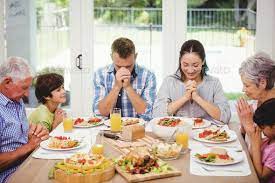 Family Sitting At Dining Table And Praying Together Before Meal By Wavebreakmedia Family Sitting At Dining Ta Food Photography Tutorial Meals Food Photography
