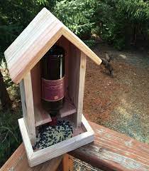 Attach one of the 11 1/4″ pieces to a trimmed corner of the piece with the circle and another trimmed square piece, using 1 1/4″ brad nails and glue. Beautiful Redwood Wine Bottle Bird Feeder One Of A Kind Made Of Hand Selected Redwood Wine Bottle Bird Feeder Diy Wine Bottle Bird Feeder Bird House Feeder