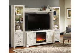 There's nothing more cozy than curling up with a blanket next to a toasty fire on a crisp evening—whether it's in your family room or your outdoor space, a fireplace will bring you all the warmth and comfort you're looking for. Bellaby 4 Piece Entertainment Center With Fireplace Ashley Furniture Homestore