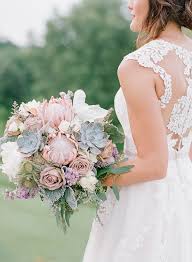 Purple bouquet of flowers and candles as a wedding decoration. Sweet Purple Vintage Wedding Aisle Society