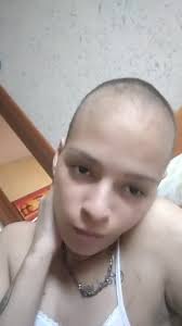 Person in Lace Tank Top Against Textured Wall