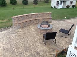 Seat walls made from concrete pavers retain the yard's sloped terrain and create an attractive patio border. Stamped Concrete Patios With Seating Wall And Fire Pit Patio Other By Delaware Decorative Concrete Houzz