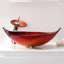 The wooden vanity countertop runs straight on as bathtub panelling and continues all the way up the wall. Jinyuze Tempered Glass Vessel Sink Hot Melted Red Gold Leaf Shaped Bathroom Vanity Sink With Waterfall Chrome Faucet Combo And Pop Up Sink Drain
