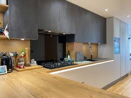 The gentle grey veining in the marble gives the walls a texture that contrasts with the flat finish on the. Dark Grey Kitchen With Vintage Oak Worktops