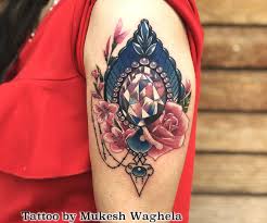 The buddha may be surrounded by additional decorative elements such as the lotus flower, sanskrit slokas, a heavenly light or aura, or images that depict a garden or a tree. Ornamental Tattoo Done By Mukesh Waghela At Moksha Tattoo Studio Goa India Goa Tattoo Center