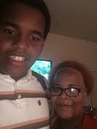 A boy my son worked with standing by one of a few trees