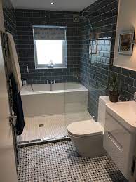 The tub, shower, and vanity share the natural light streaming through the undressed window. Look At The Great Use Of Space With A Bath And A Shower In This Innovative Design David F Small Bathroom Remodel Small Bathroom Small Bathroom Remodel Designs