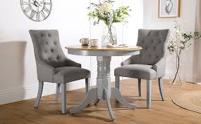 Sets with a blonde hue pair especially well with contemporary decor, while medium oak dining room chairs bring all the warmth of classic decorating to your table. Kingston Round Painted Grey And Oak Dining Table With 2 Duke Light Grey Fabric Chairs Furniture And Choice