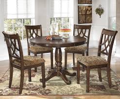 Leahlyn 5 Piece Cherry Finish Round Dining Table Set By Signature Design By Ashley At Rife S Home Round Dining Table Sets Round Dining Room Round Dining Table