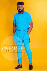 Above right, menswear designer, yomi casual looks sharp in a cream colour senator style outfit that has a contrasting coffee colour neck and pocket trimmings. Noble Igwe Yomi Casual 4 Yomi Casual African Shirts For Men African Clothing For Men