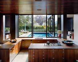 A metallic ceiling for the kitchen can never be this stunning. Sunken Open Kitchen With Built In Nook Wood Ceiling Matching Wood Cabinets By Marmol Radziner 1280x1019 Roomporn
