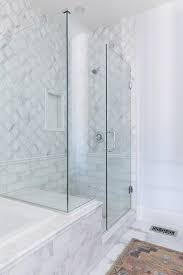 A Seamless Glass Shower Features A Marble Bench Fixed Facing A Polished Nickel Shower Head Mounted Marble Shower Tile White Marble Shower Bathroom Remodel Tile