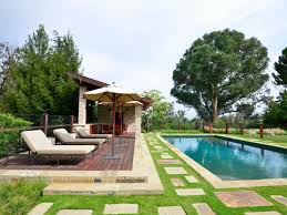 A New Deck And Craftsman Style Pool House Give Residents And Guests A Place To Lounge Swimming Pool Landscaping Backyard Pool Landscaping Pool Landscape Design