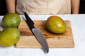 Use the serrated edge knife to cut the mango into three pieces. How To Cut A Mango 5 Easy Hacks Fresh N Lean