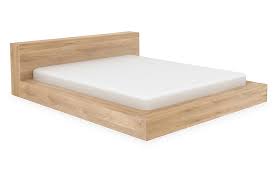 A full framed bed without a foot board and a quality upholstered head panel. Ethnicraft Madra Platform Bed Oak One Kings Lane