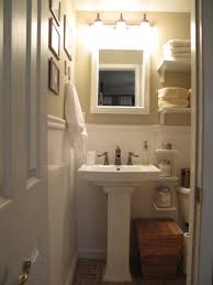 A pedestal sink plays a pivotal role in how this bathroom melds traditional and contemporary elements, such as the subway tile accented by a band of mosaic tile. Pedestal Sink Small Powder Bathroom Ideas Novocom Top