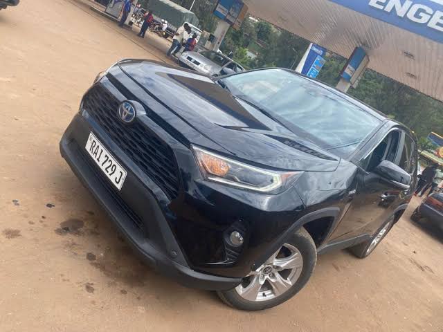 Toyota RAV4 4x4 SUV car rental parked at a local fueling station area within Kigali city limits